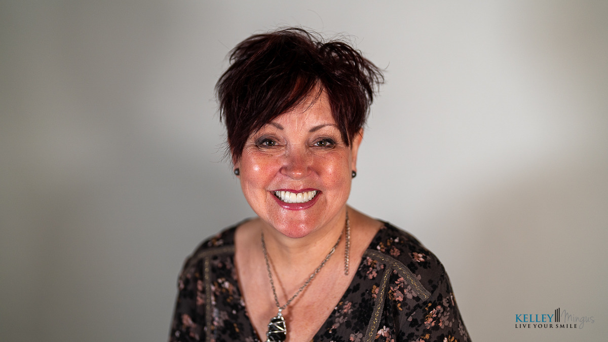 A smiling woman with dark short hair wearing a pendant necklace, appearing in content about CPAP alternatives for sleep apnea, with the Kelley Mingus logo in the bottom right corner.